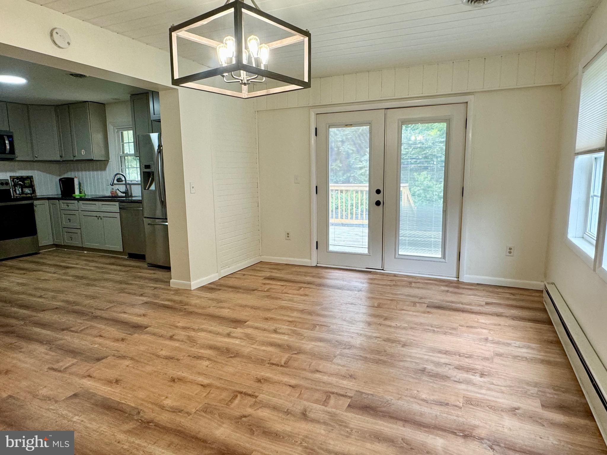1380 Sand Hill Road Hummelstown, PA 17036 - Photo 5 of 22 an empty room with wooden floor a ceiling fan and windows