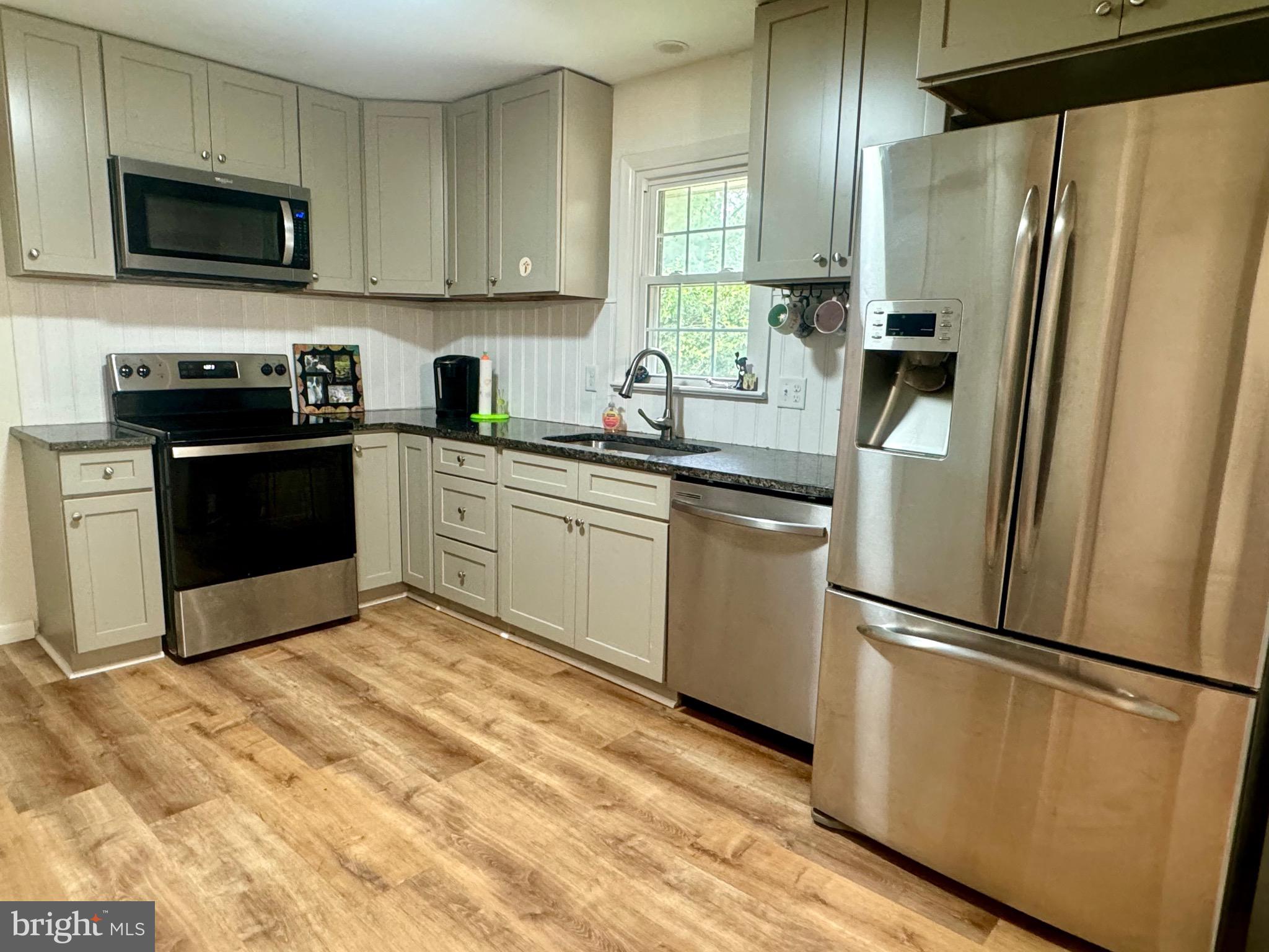 1380 Sand Hill Road Hummelstown, PA 17036 - Photo 6 of 22 a kitchen with stainless steel appliances granite countertop a refrigerator sink and microwave