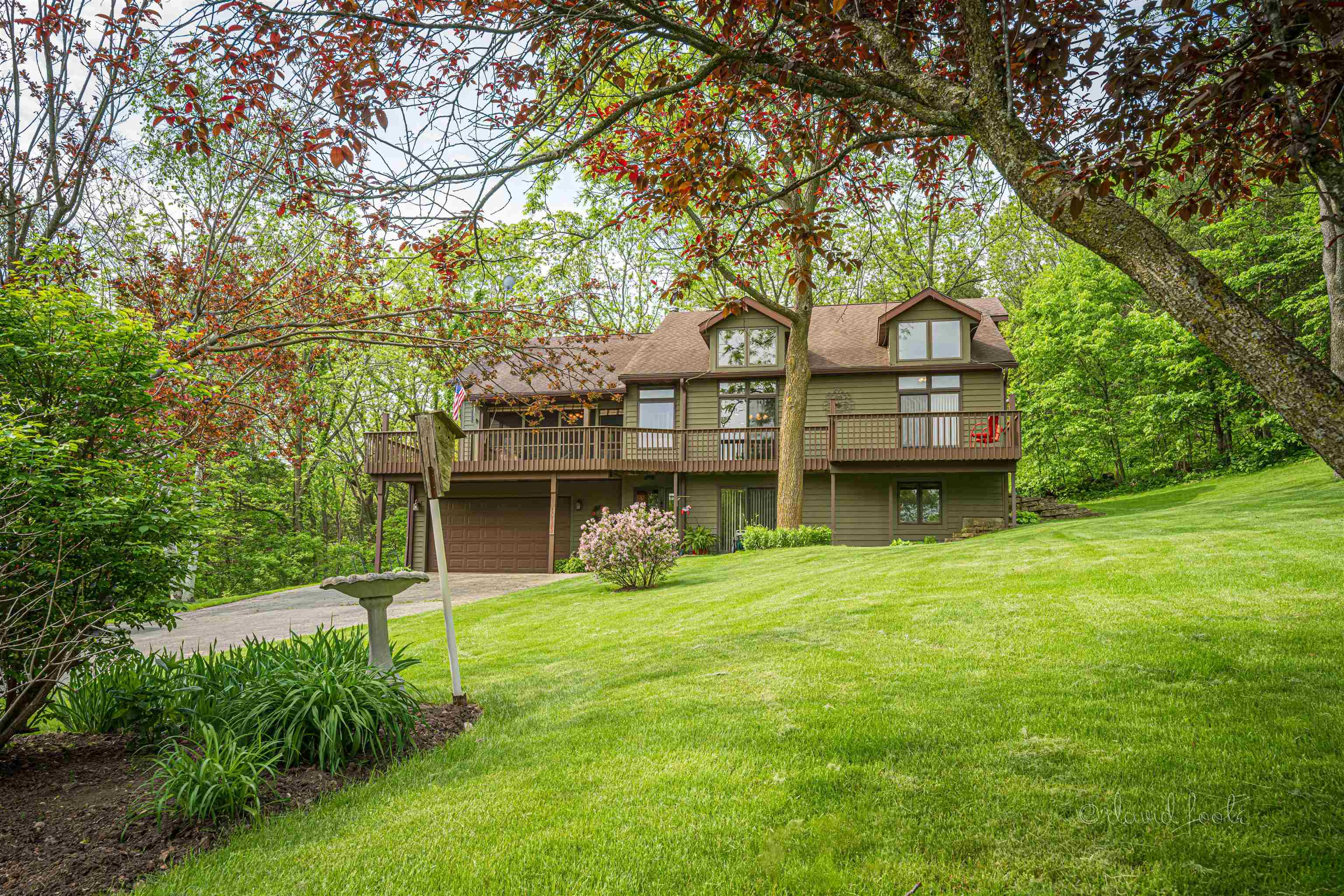 108 West Glen Hollow Road Galena, IL 61036 - Photo 2 of 51 a front view of a house with a garden and trees