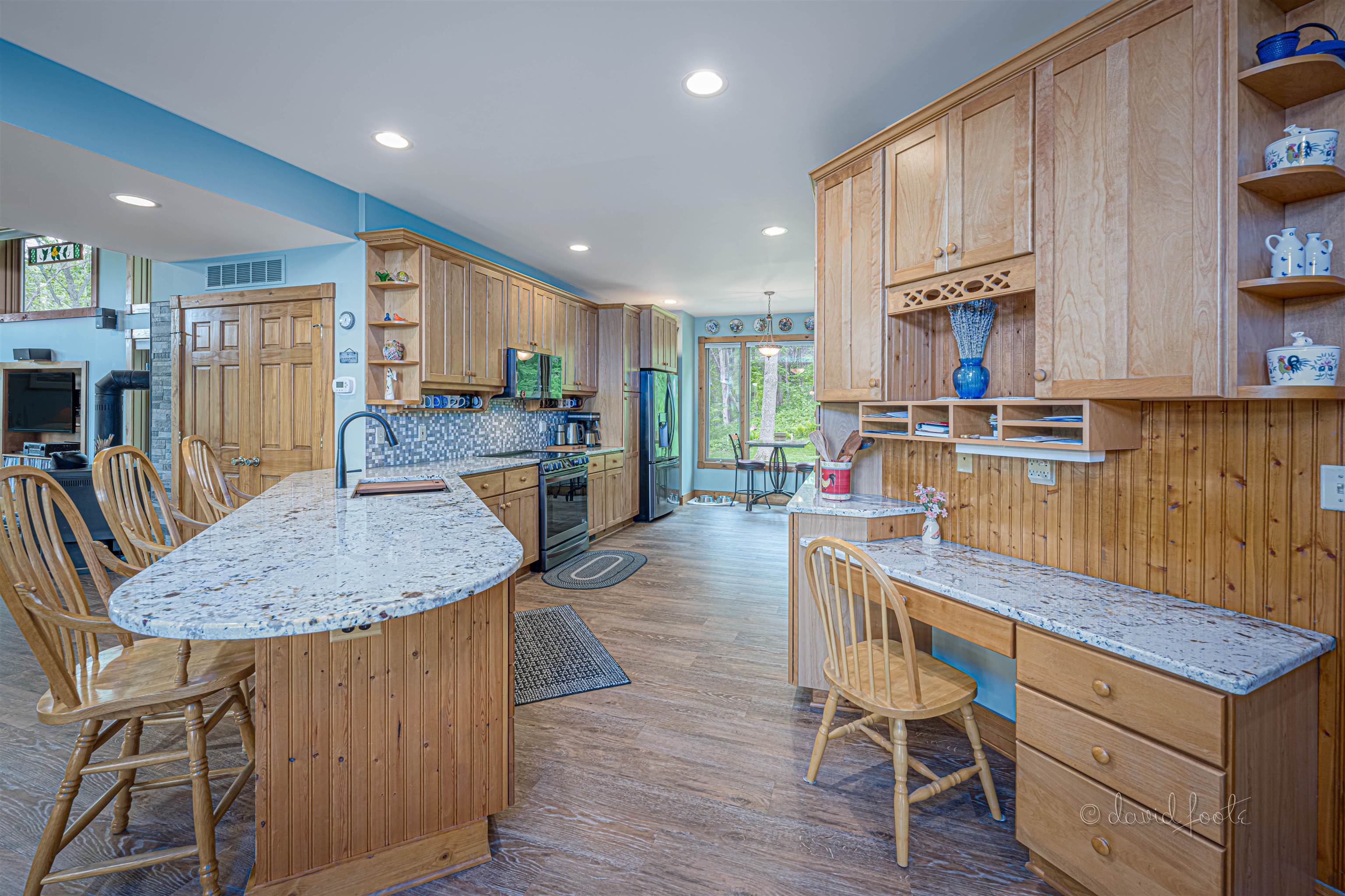 108 West Glen Hollow Road Galena, IL 61036 - Photo 7 of 51 a kitchen with stainless steel appliances granite countertop table chairs sink and wooden floor