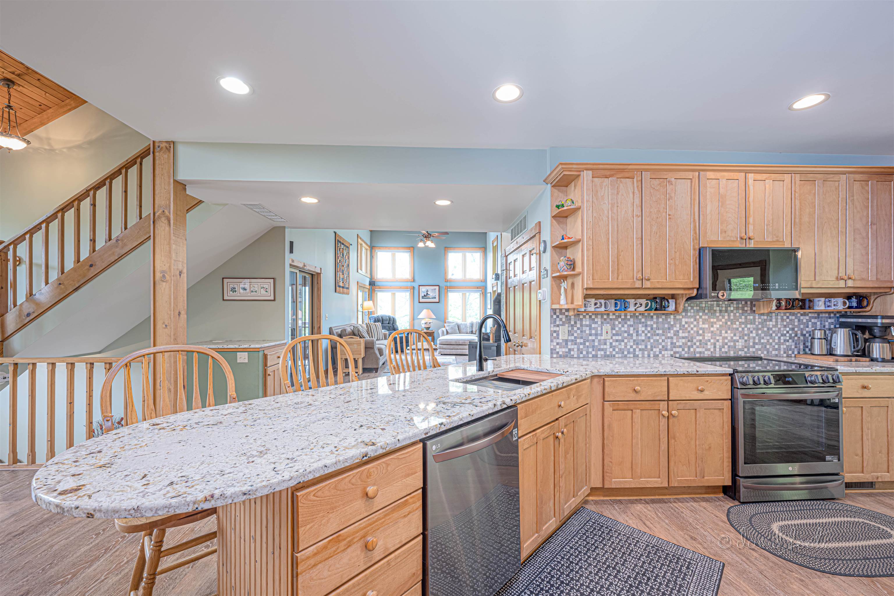 108 West Glen Hollow Road Galena, IL 61036 - Photo 8 of 51 a kitchen with granite countertop a sink a stove a dining table and chairs