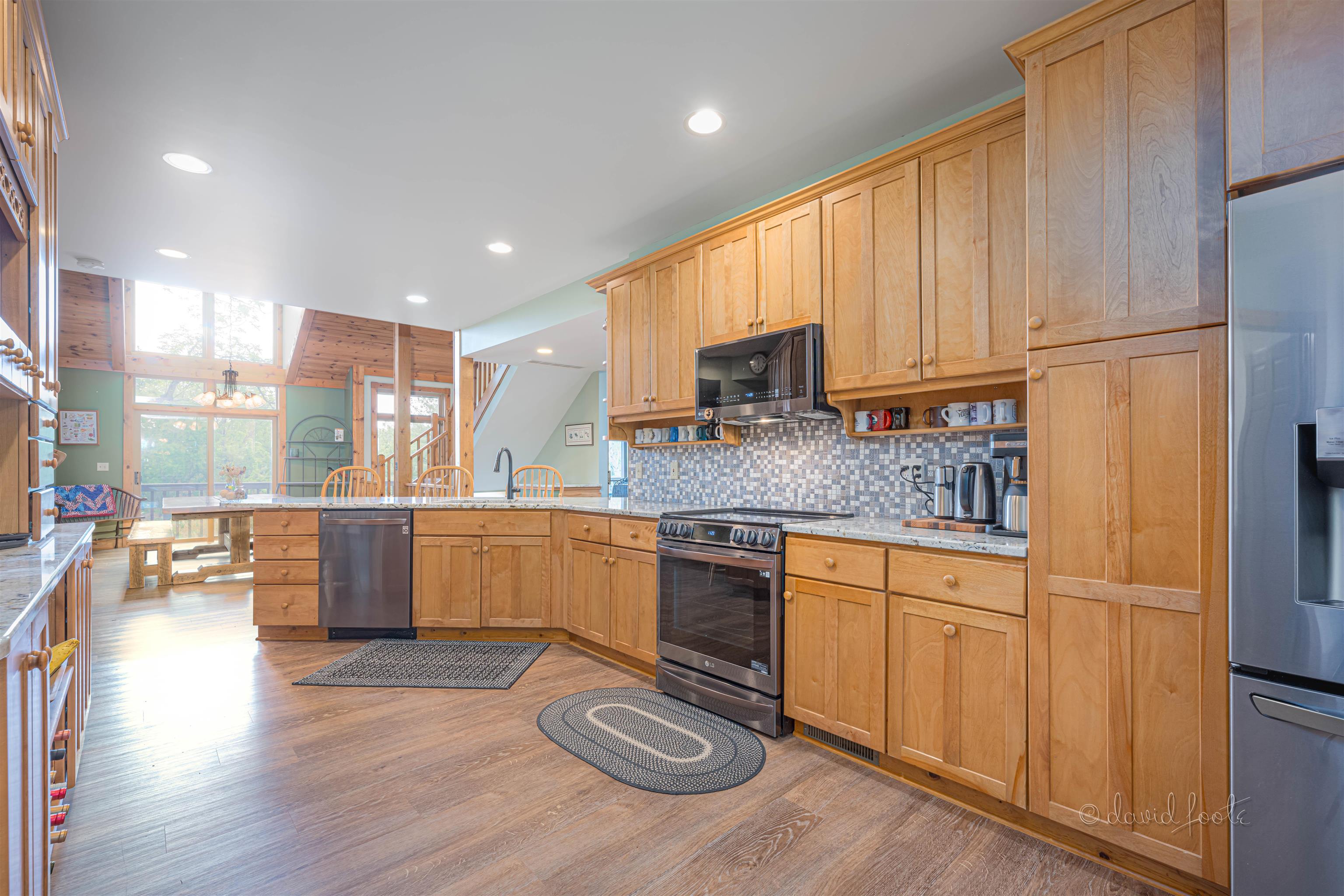 108 West Glen Hollow Road Galena, IL 61036 - Photo 9 of 51 a kitchen with granite countertop wooden floors stainless steel appliances and sink