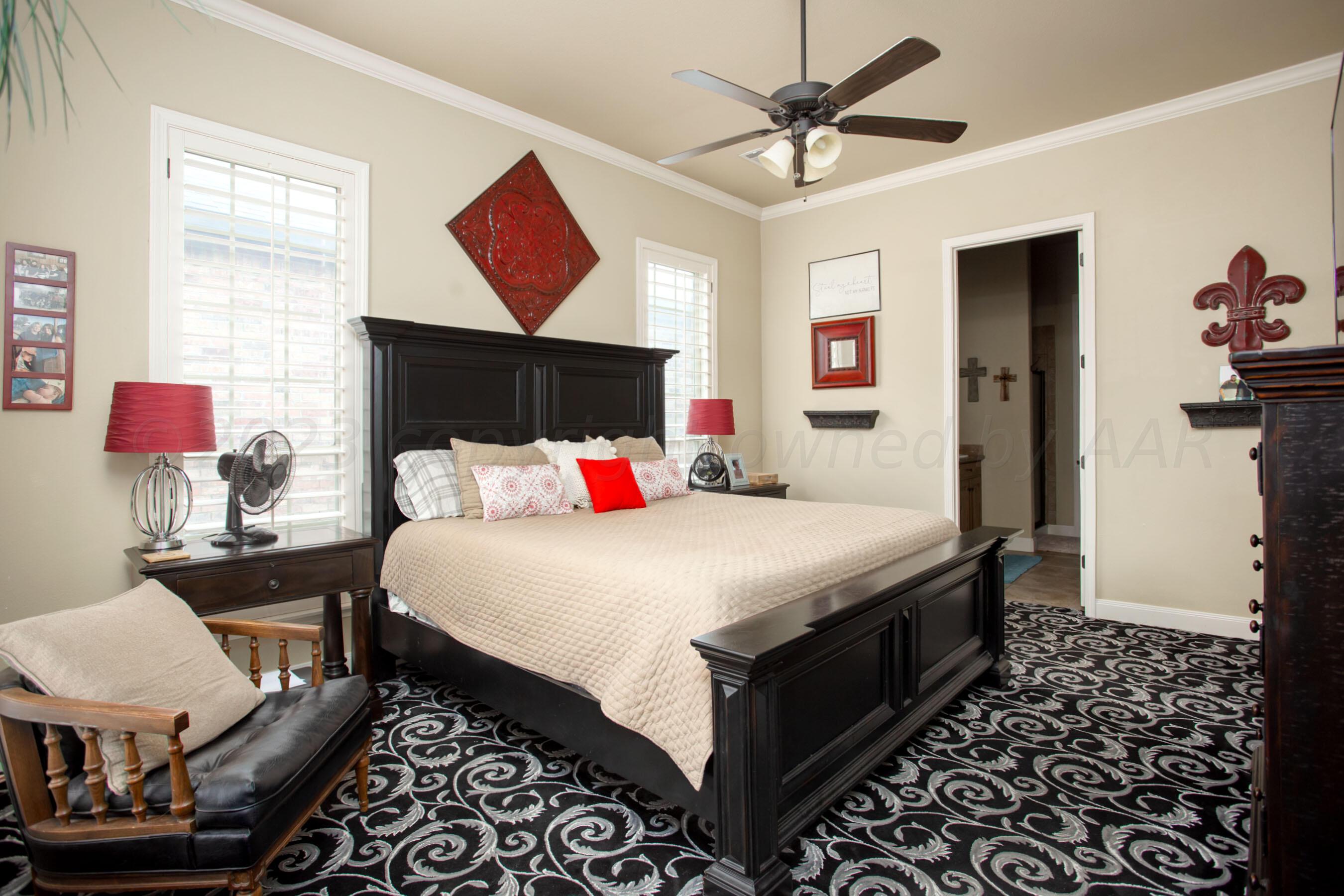 7105 Nick Street Amarillo, TX 79119 - Photo 11 of 24 a bed room with a bed and a chandelier