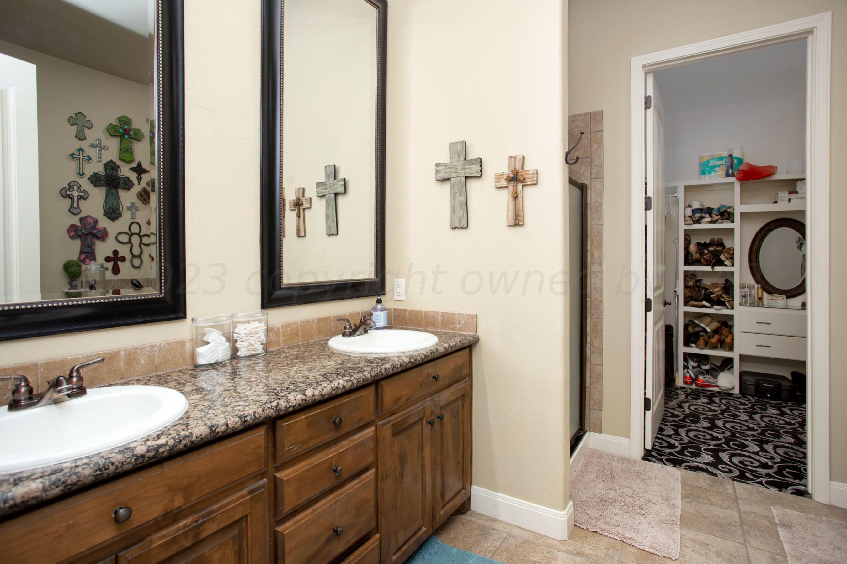 7105 Nick Street Amarillo, TX 79119 - Photo 13 of 24 a bathroom with a granite countertop sink and a mirror