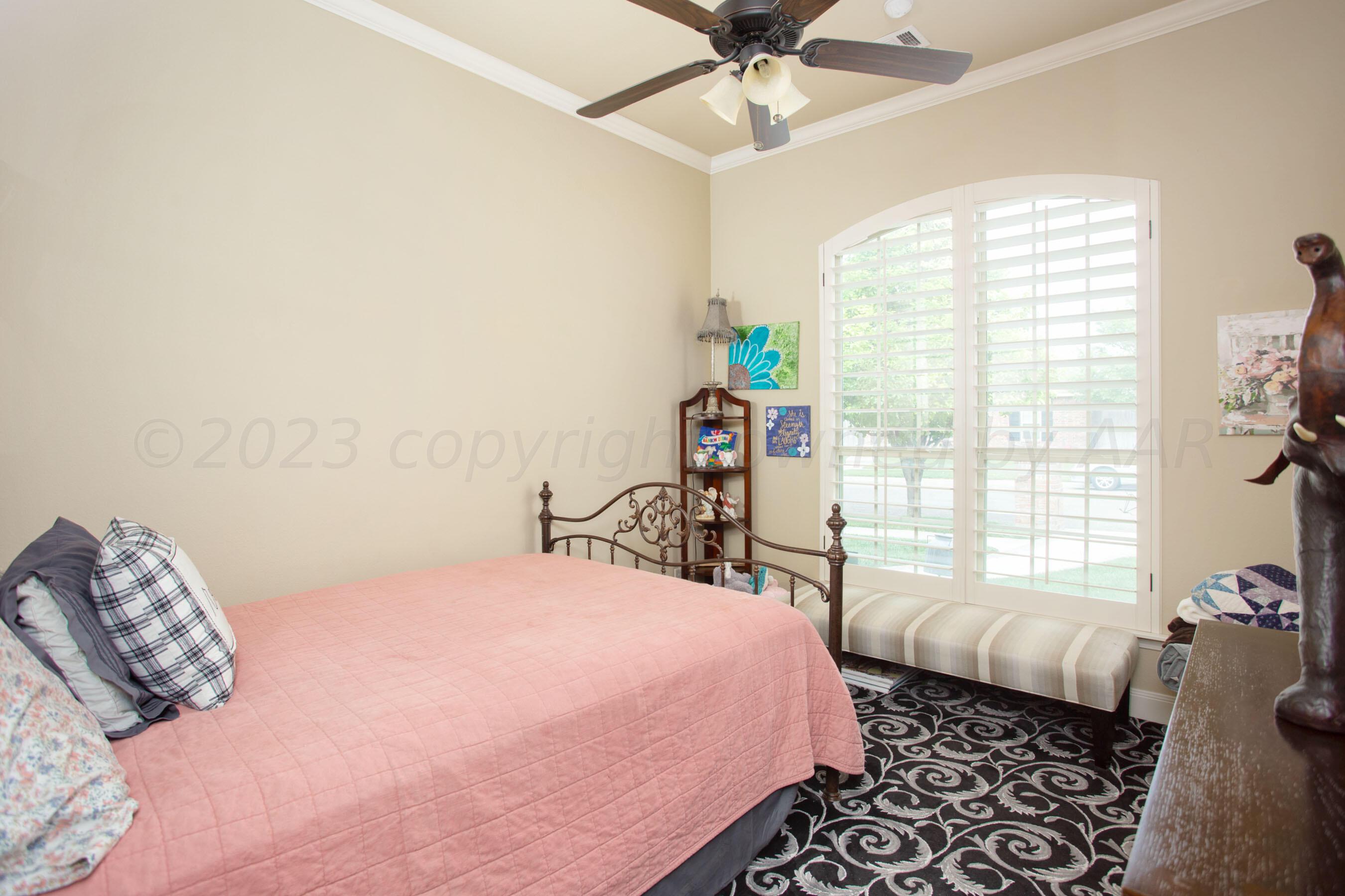 7105 Nick Street Amarillo, TX 79119 - Photo 16 of 24 a bedroom with a bed and a window