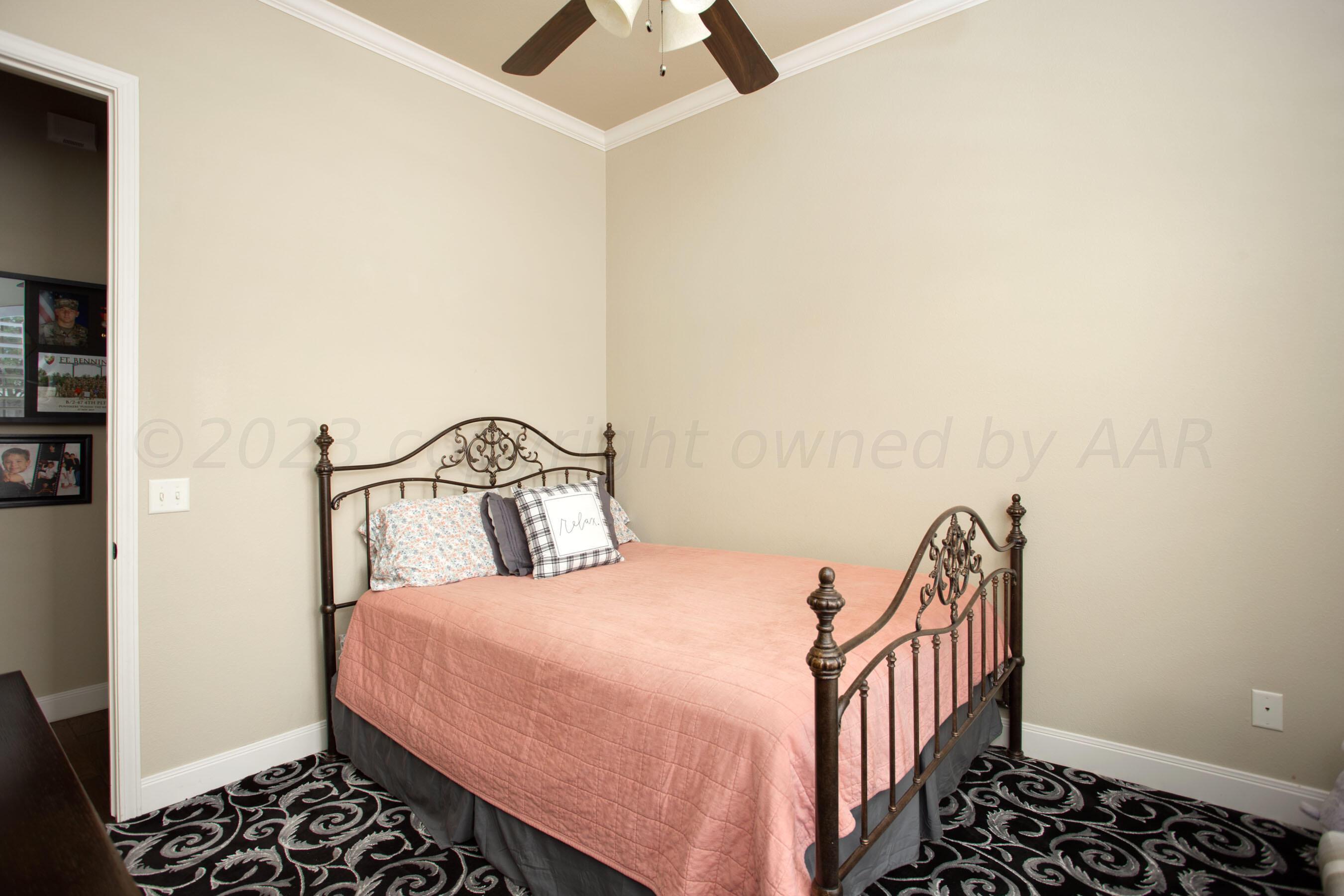 7105 Nick Street Amarillo, TX 79119 - Photo 17 of 24 a bedroom with a bed and a window