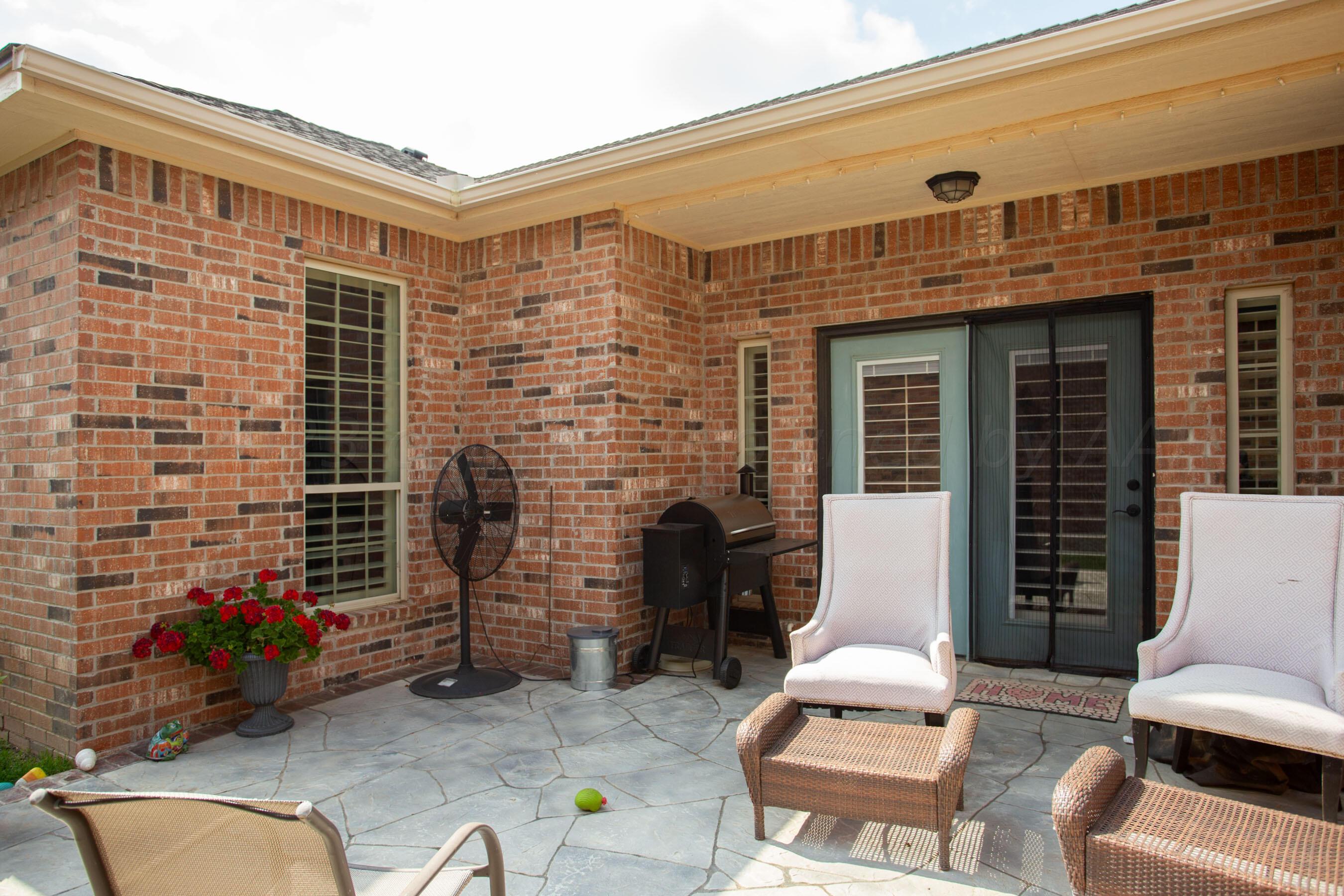 7105 Nick Street Amarillo, TX 79119 - Photo 22 of 24 a view of a patio with couches and a dining table and chairs with wooden floor