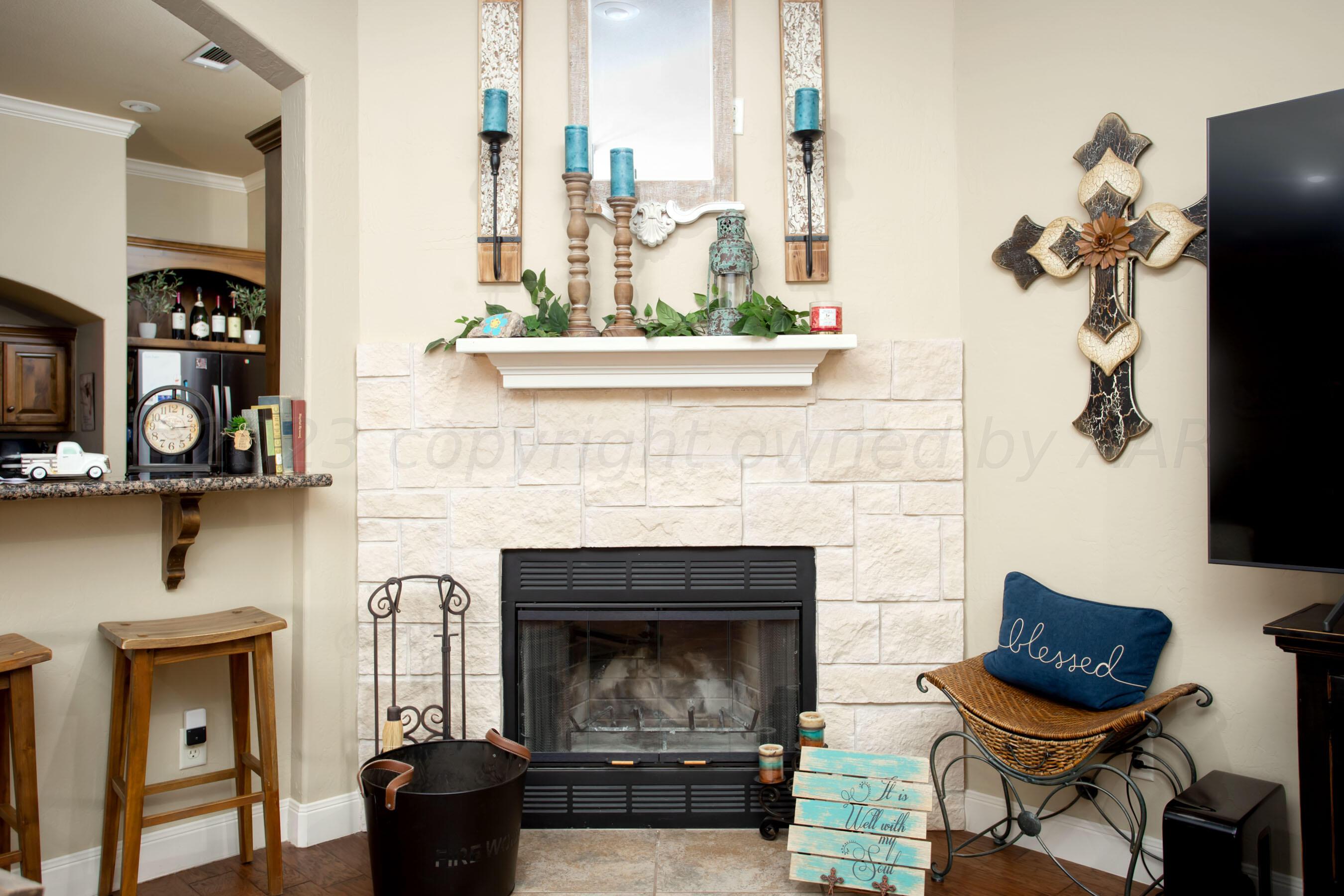 7105 Nick Street Amarillo, TX 79119 - Photo 6 of 24 a living room with furniture and a fireplace