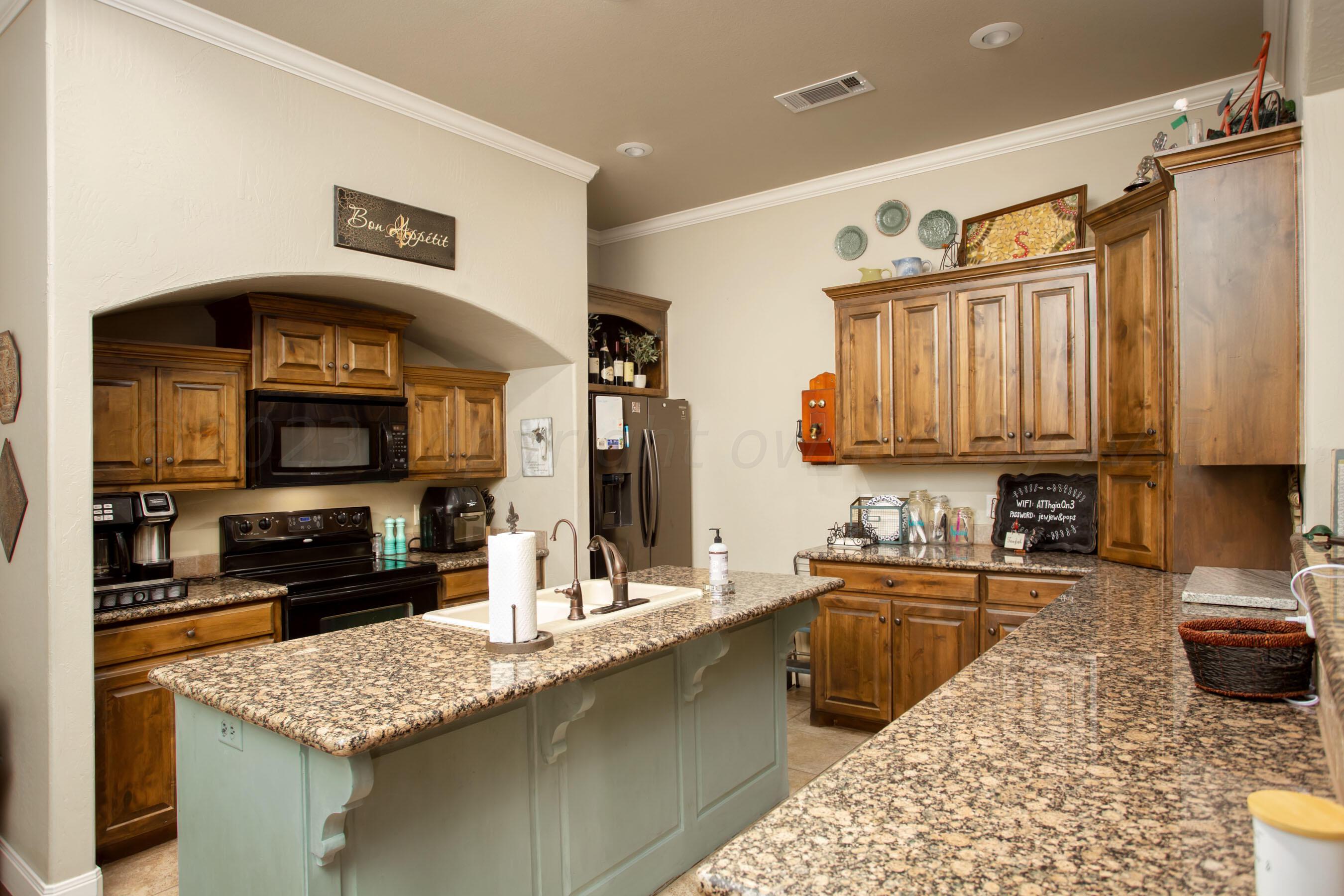 7105 Nick Street Amarillo, TX 79119 - Photo 7 of 24 a kitchen with stainless steel appliances granite countertop a sink stove and refrigerator