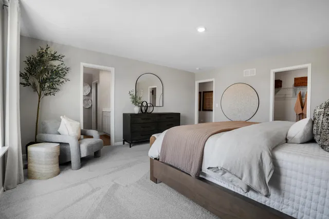 a bedroom with bed and a potted plant