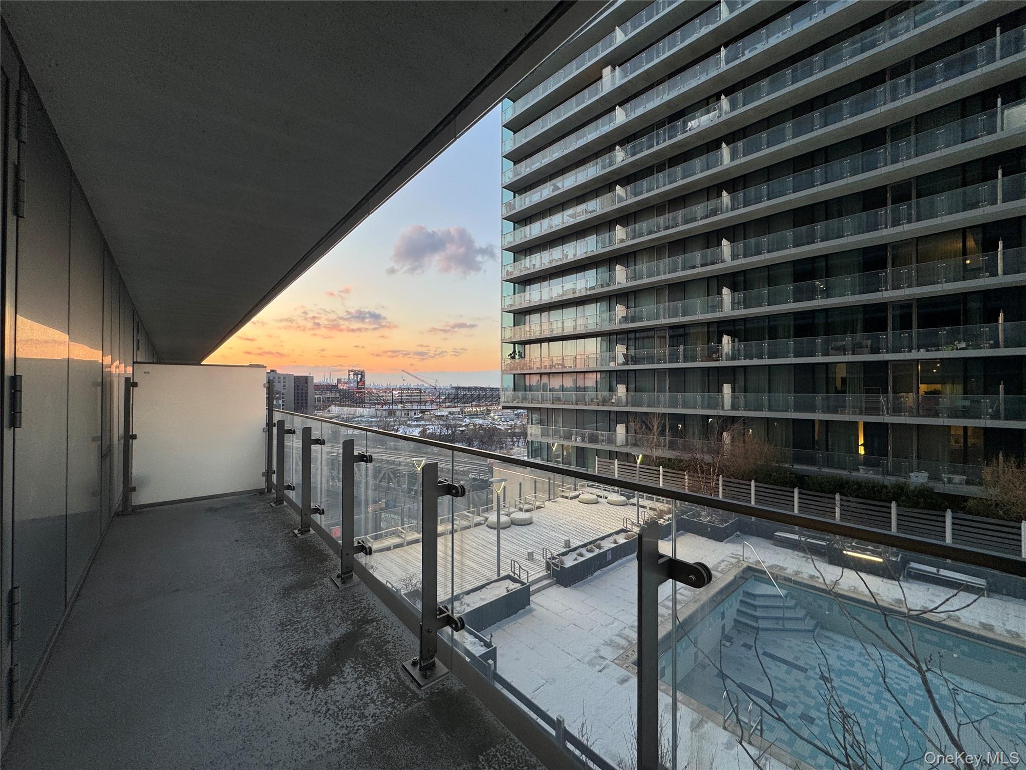 131-03 40 Road, Unit 10H Queens, NY 11354 - Photo 9 of 14 a balcony with hardwood wall and deck