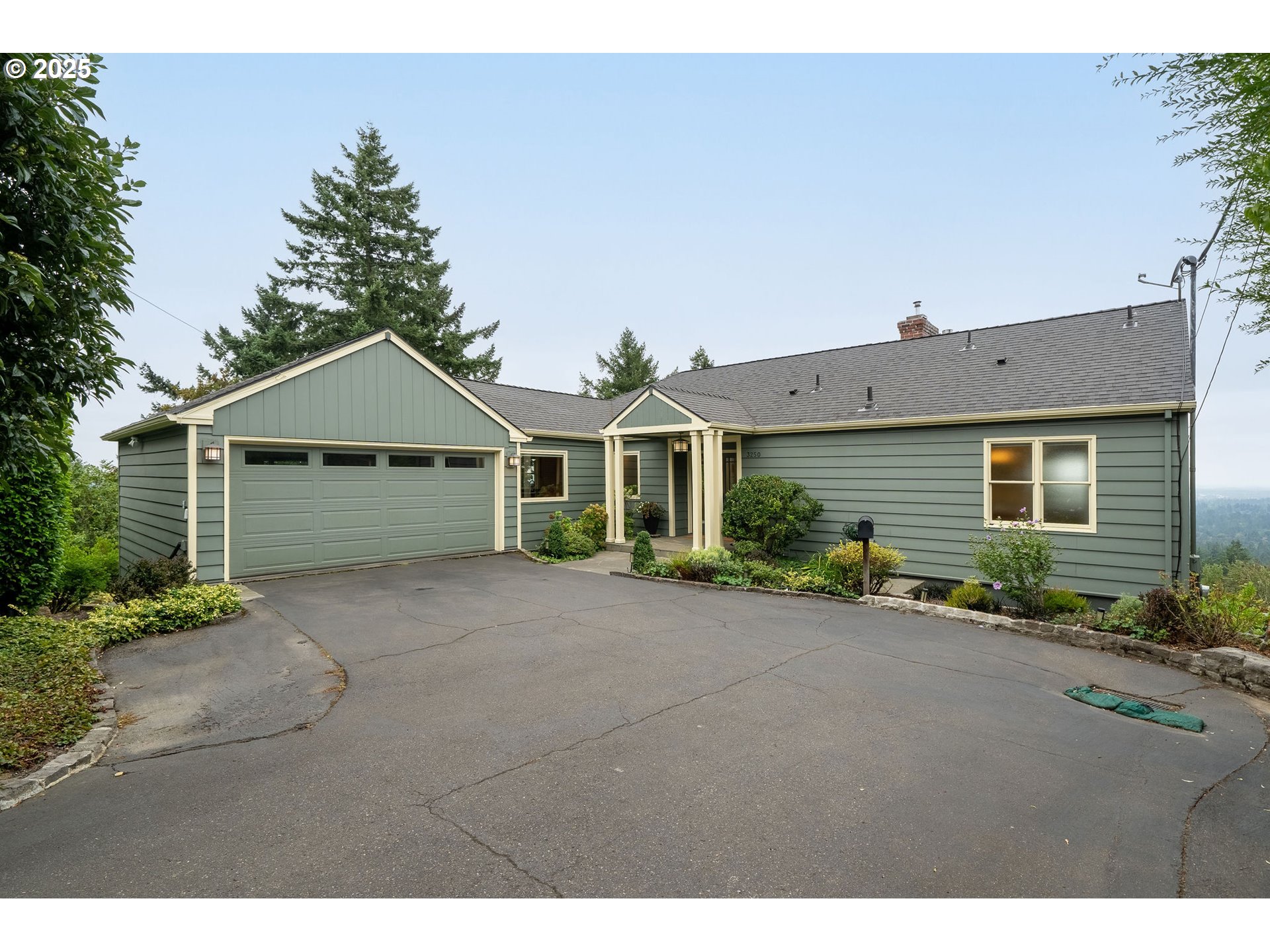 3250 Southwest Donner Way Court Portland, OR 97239 - Photo 1 of 48 a front view of a house with a yard and garage