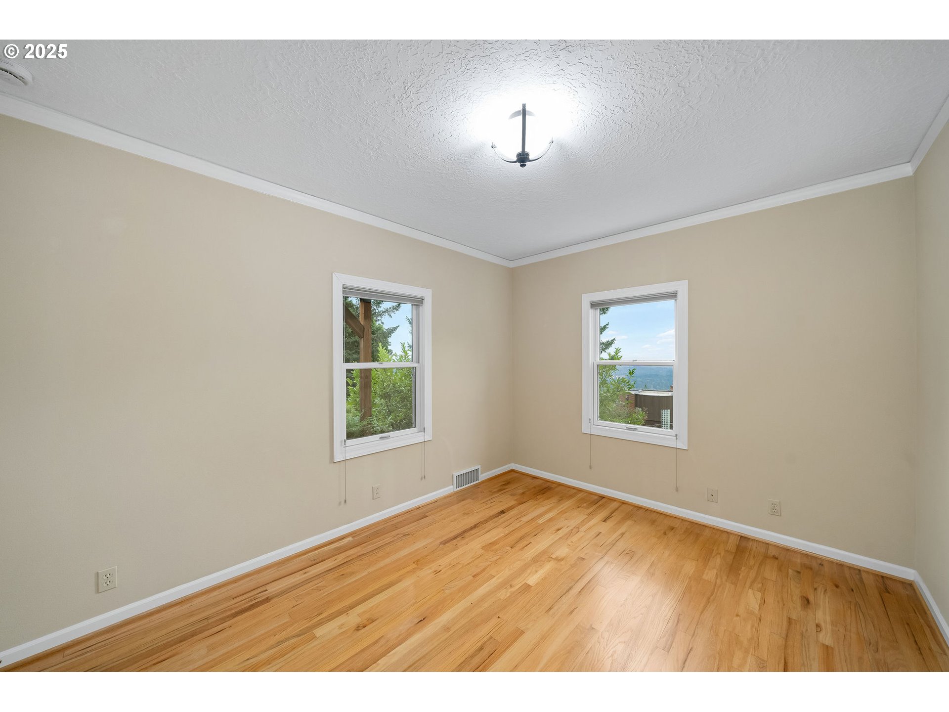 3250 Southwest Donner Way Court Portland, OR 97239 - Photo 25 of 48 a view of an empty room with a window and wooden floor