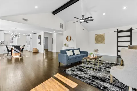 a living room with furniture and wooden floor