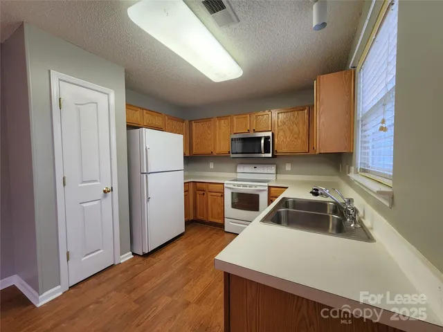 a kitchen with a sink a stove and refrigerator