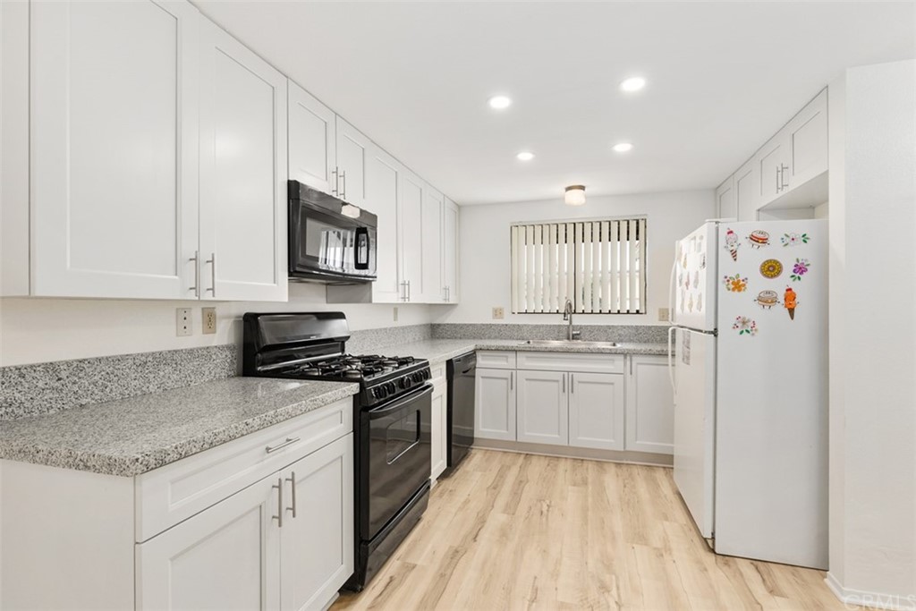 1467 Nolette Avenue Hemet, CA 92545 - Photo 5 of 10 a kitchen with granite countertop cabinets stainless steel appliances and a counter space