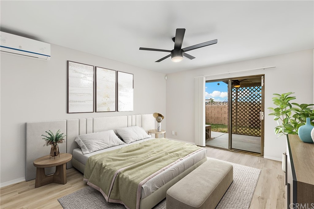 1467 Nolette Avenue Hemet, CA 92545 - Photo 8 of 10 a bedroom with a large bed and a chandelier