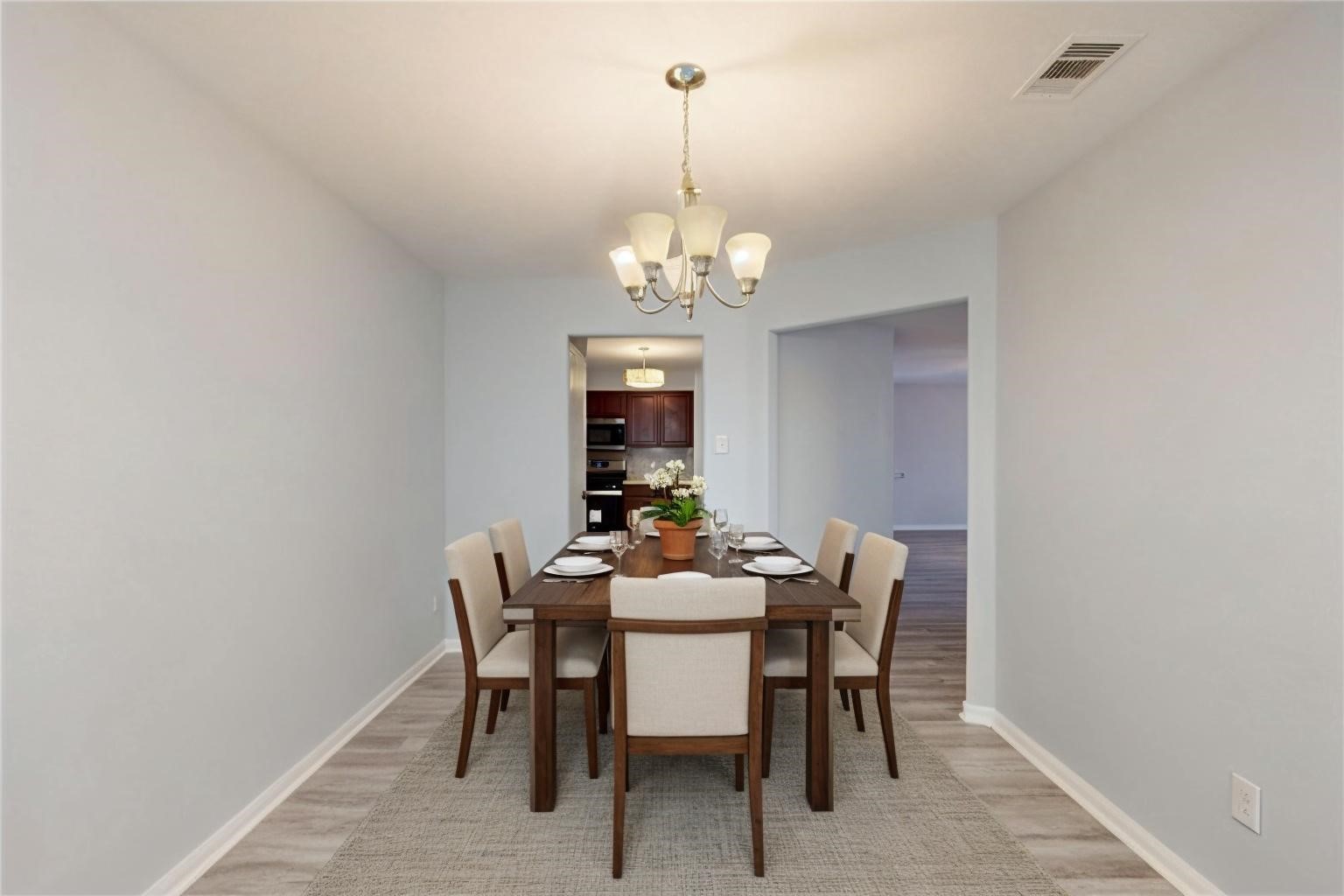 9877 Lace Flower Way Conroe, TX 77385 - Photo 15 of 43 a dining room with furniture a chandelier and a rug