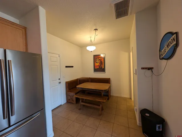 a room with a bed and a chandelier