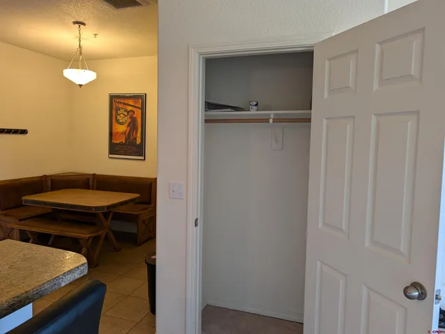 a view of a room with a table and chairs