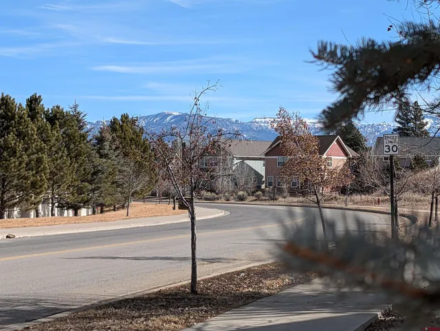 a view of a street with a building in the background