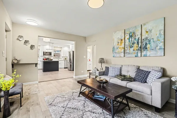 a living room with furniture a rug and white walls