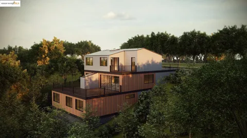 an aerial view of a house with yard and trees in the background