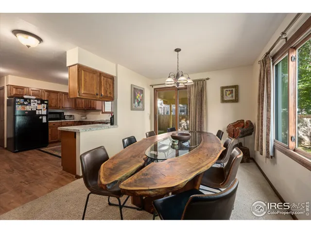 a view of a dining room with furniture and chandelier