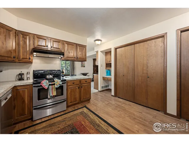 a kitchen with stainless steel appliances granite countertop a stove a sink dishwasher and a refrigerator