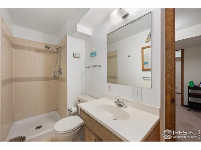 a bathroom with a sink toilet a mirror and shower