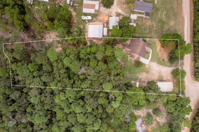 an aerial view of a houses with a yard
