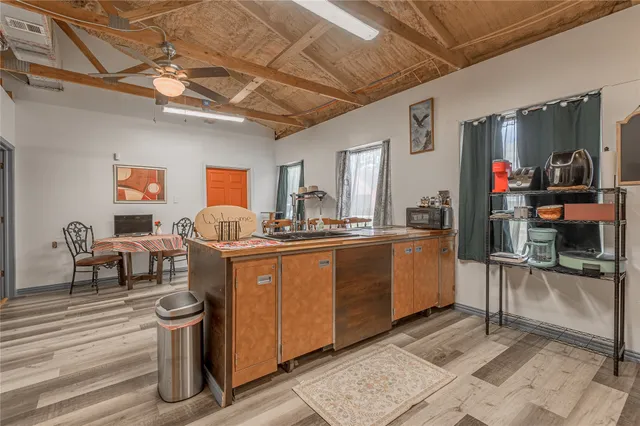 a living room with furniture a flat screen tv and a table