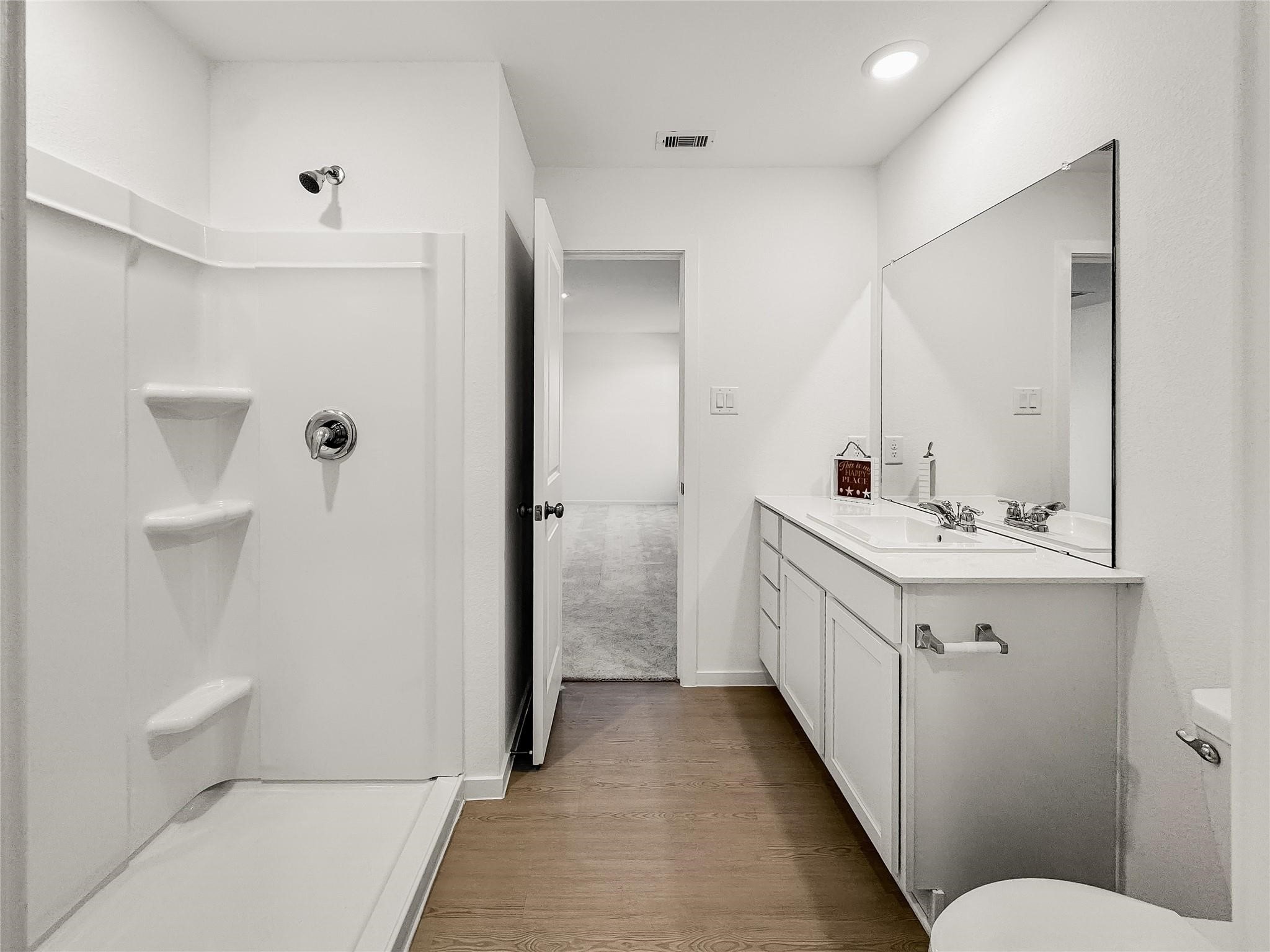 12430 Wild Strawberry Road Houston, TX 77038 - Photo 18 of 34 Primary bathroom featuring a stylish walk-in shower, double vanity, and contemporary fixtures for a luxurious feel.