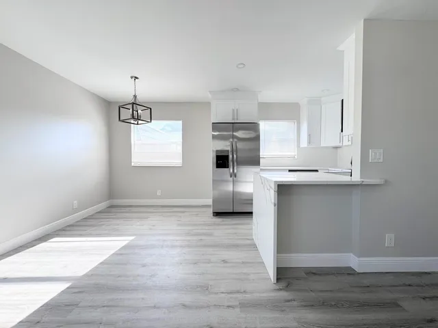 a view of a kitchen with microwave and cabinets