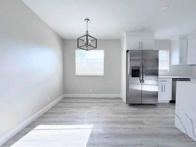 a view of a kitchen with a sink and dishwasher a refrigerator