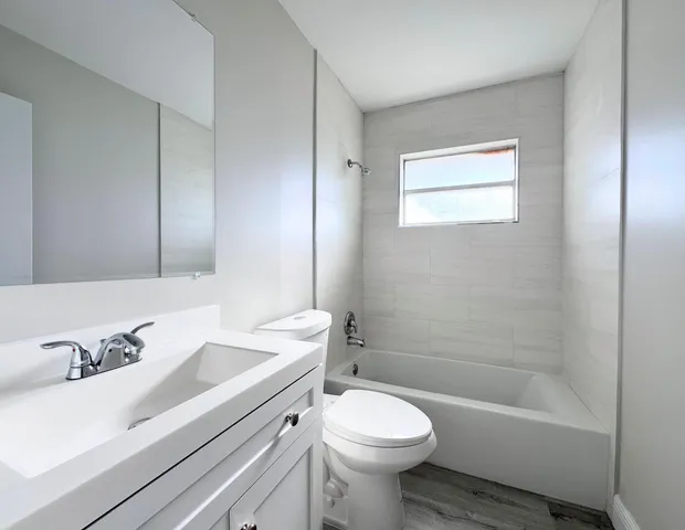 a bathroom with a sink a toilet and a bathtub