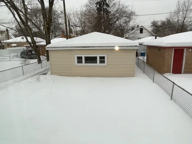a front view of a house with yard and trees