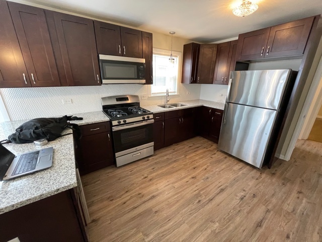 12312 South May Street Calumet Park, IL 60827 - Photo 5 of 11 a kitchen with granite countertop a refrigerator stove top oven and sink