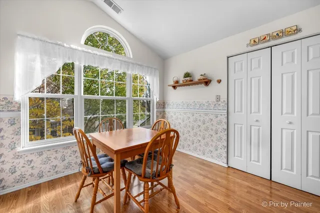a view of a dining room with furniture window and wooden floor