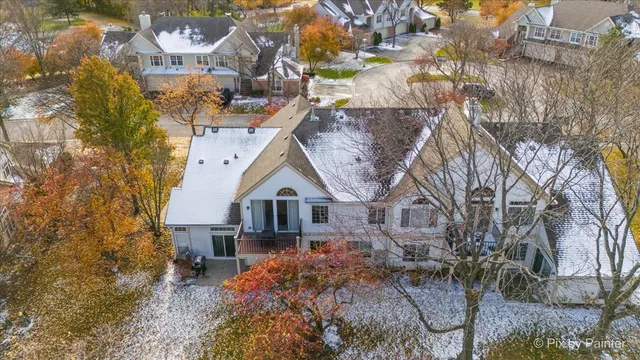 a front view of a house with a yard and large trees