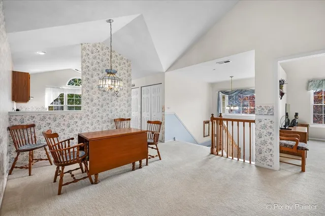 a view of hall way with furniture and chandelier