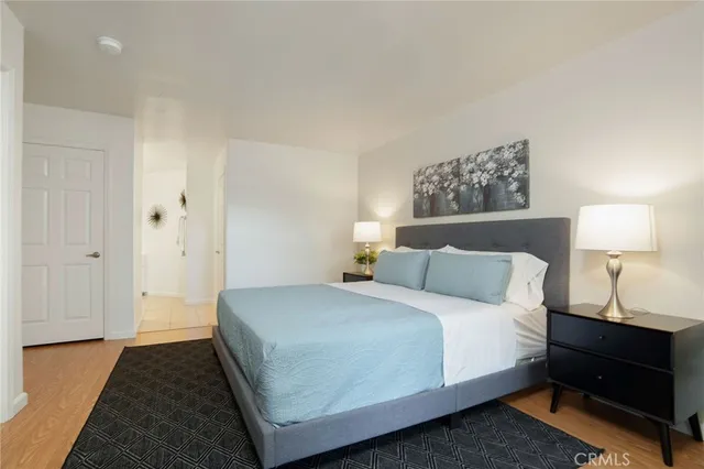 a bedroom with a bed and a lamp