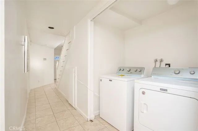 a view of a storage & utility room with dryer and washer