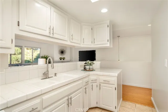 a kitchen with white cabinets and a sink
