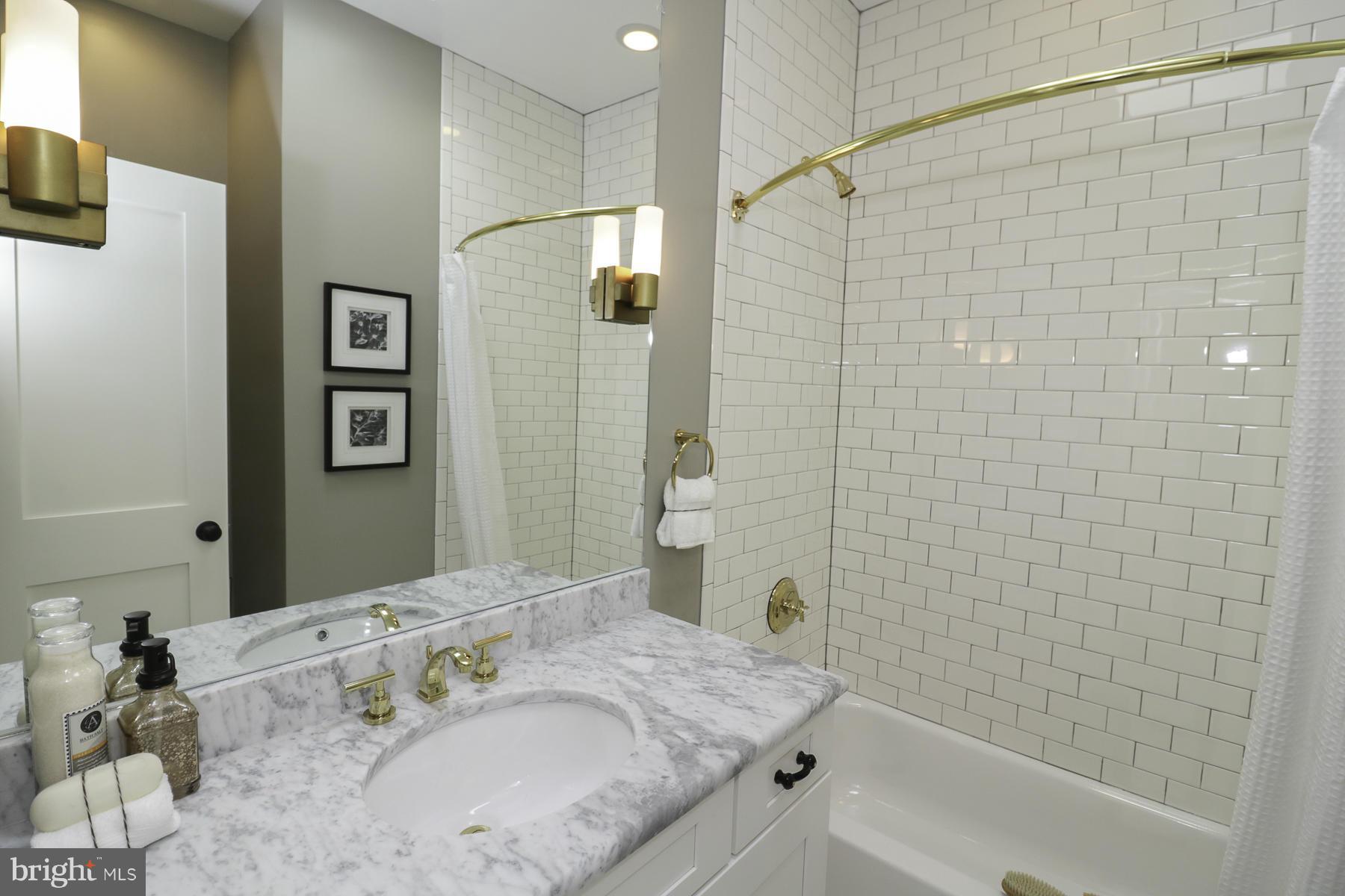 124 11th Street Northeast Washington, DC 20002 - Photo 22 of 30 a bathroom with a granite countertop sink a mirror and shower
