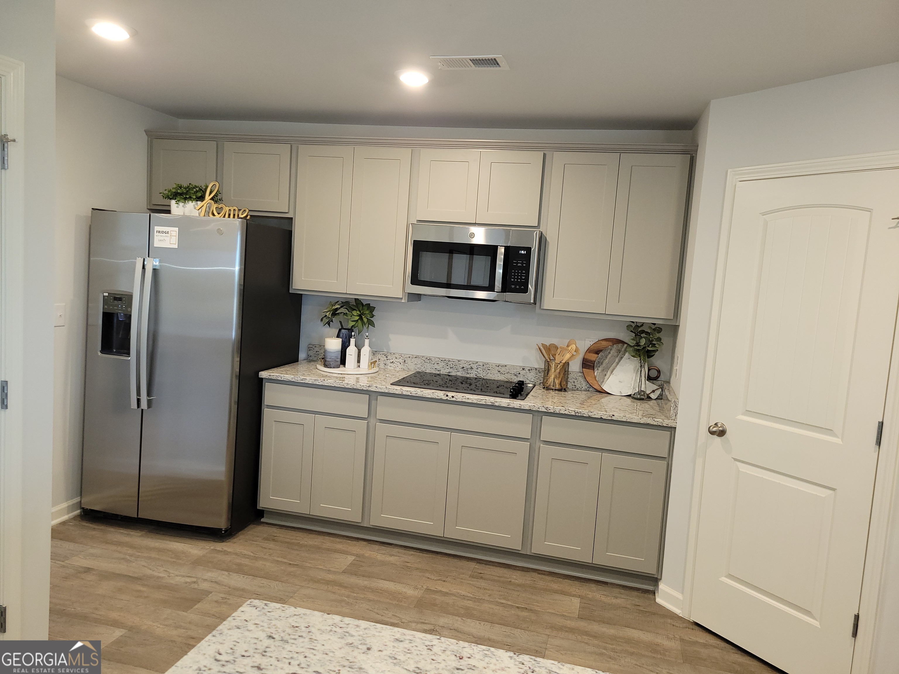 505 Holsteiner Road, Unit 66 Hogansville, GA 30230 - Photo 11 of 11 a kitchen with stainless steel appliances granite countertop a refrigerator and a sink