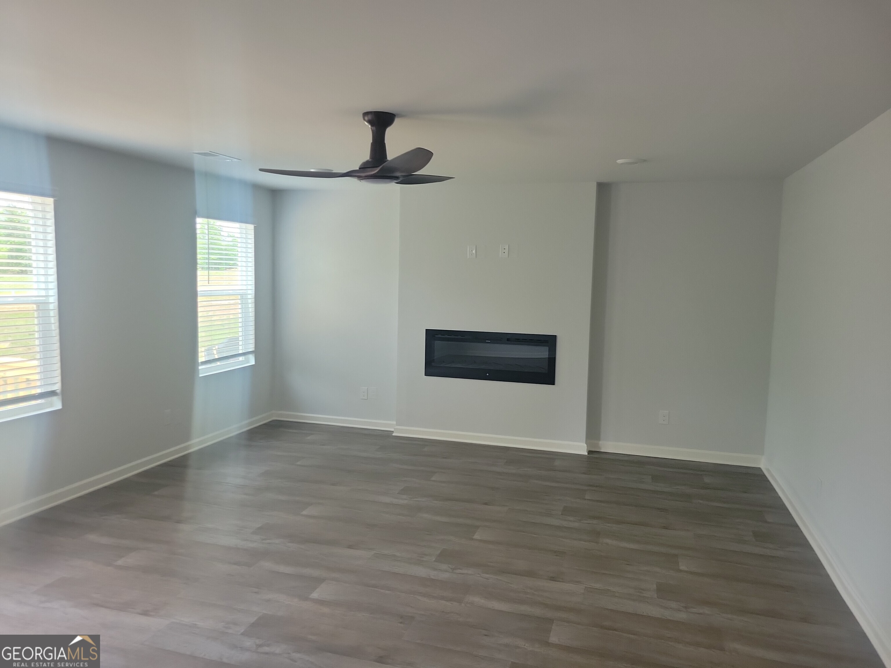 505 Holsteiner Road, Unit 66 Hogansville, GA 30230 - Photo 5 of 11 a view of an empty room with wooden floor and a window