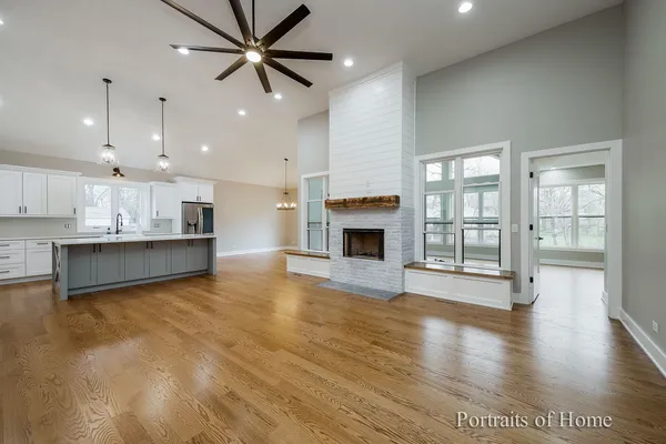 a view of an empty room with a kitchen and kitchen view