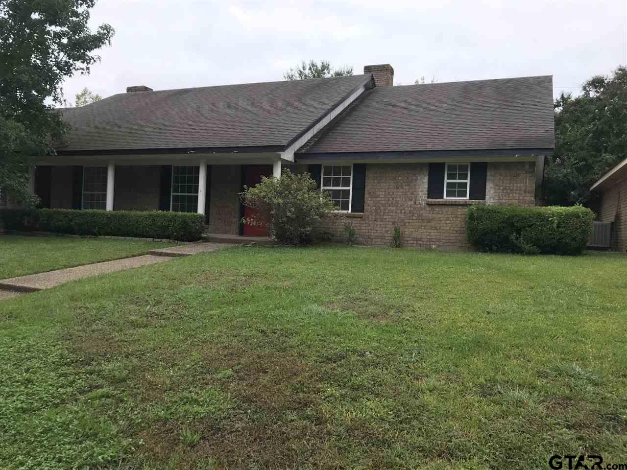 3721 Colony Park Drive Tyler, TX 75701 - Photo 1 of 11 a front view of a house with a garden and yard