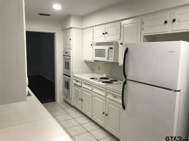 a kitchen with stainless steel appliances a refrigerator sink and stove